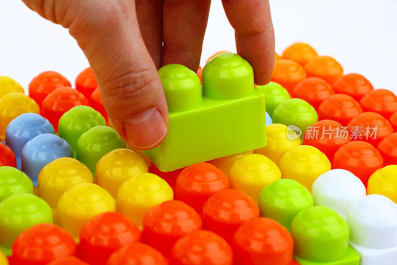 Hand is buildings with toy bricks